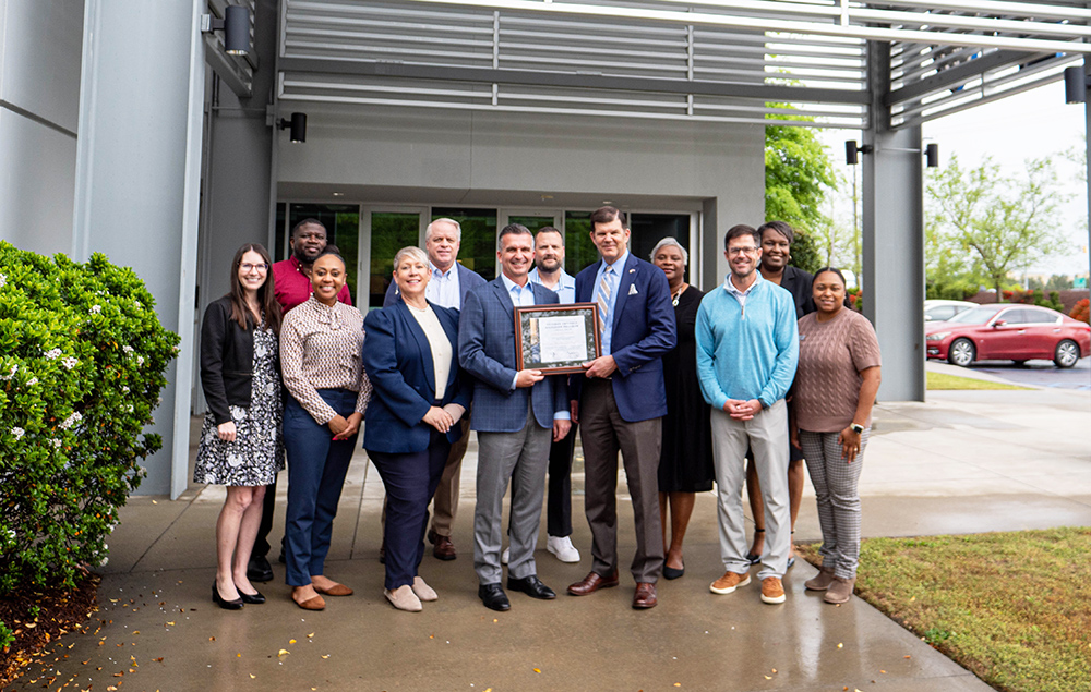 Secretary McCaffrey posing with Blue Cross staff