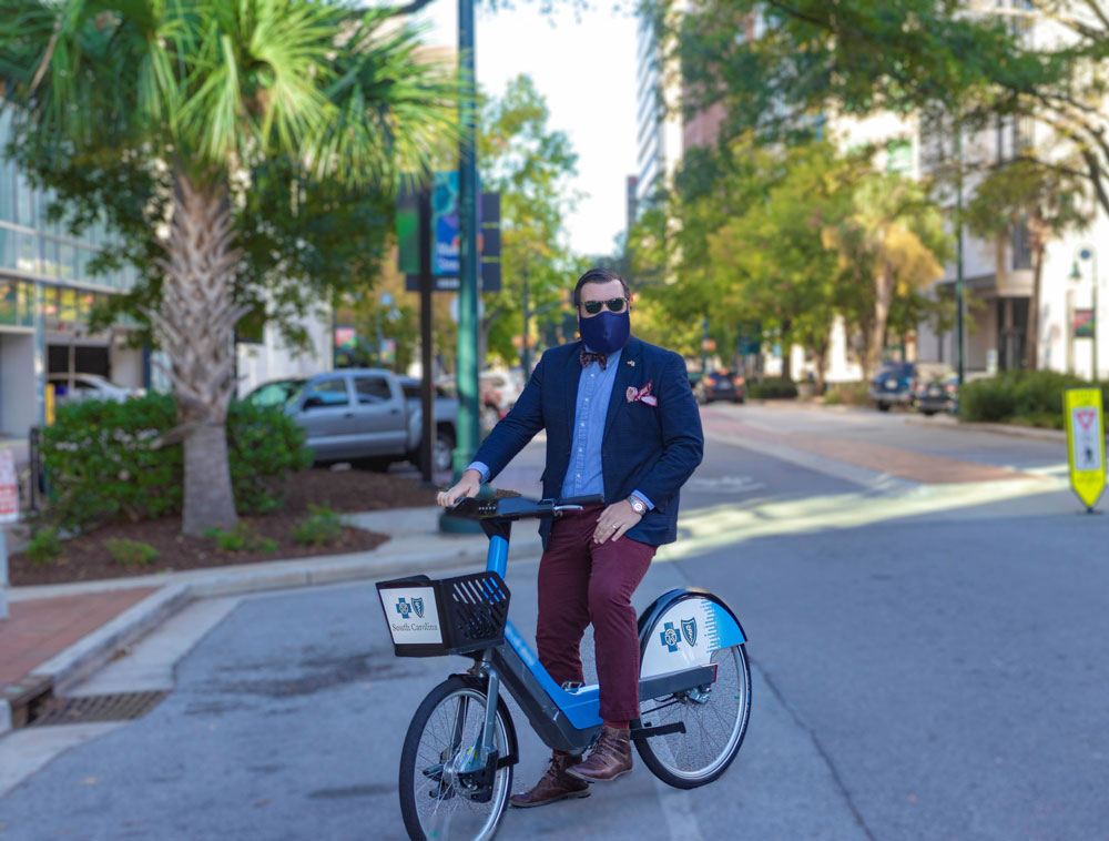 man wearing a mask rides Blue Bike 