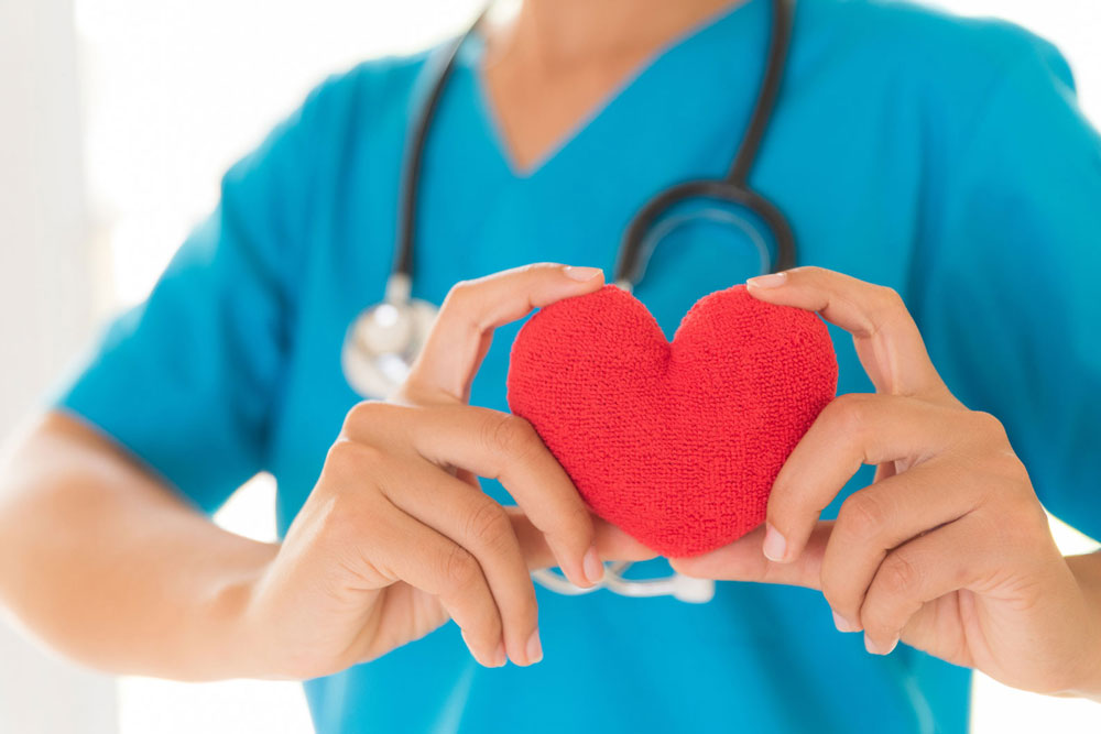 Nurse holding a plush heart