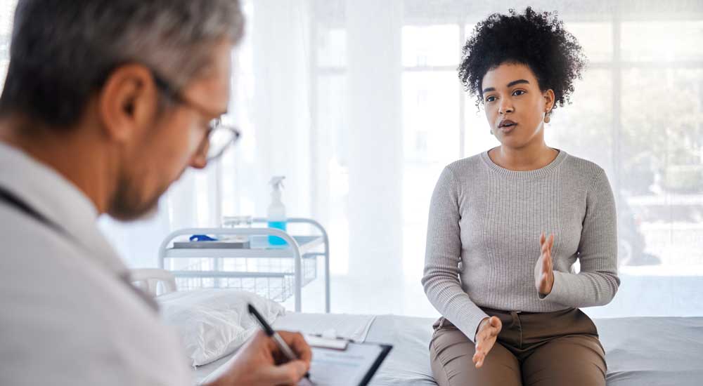woman talking to doctor in white coat 