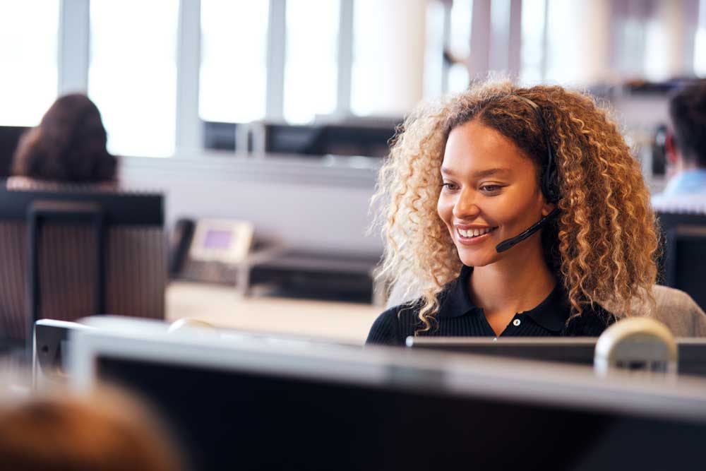 woman wearing headset in cubicle