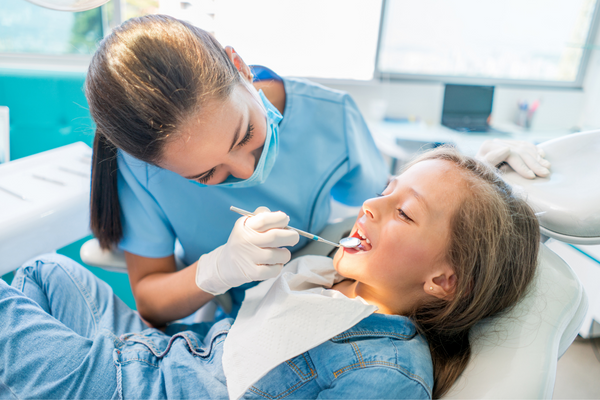 Dentist examines childs teeth
