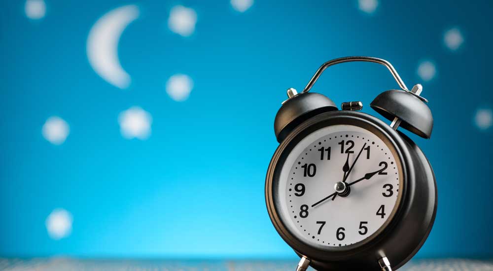 clock with blue background and stars and moon in background