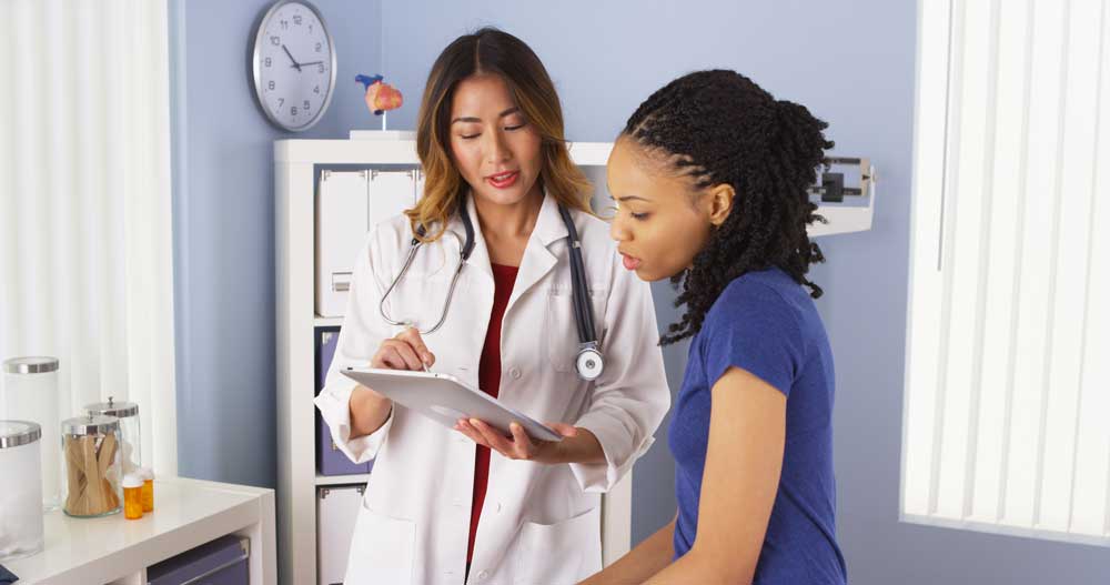 woman talking with doctor in white coat