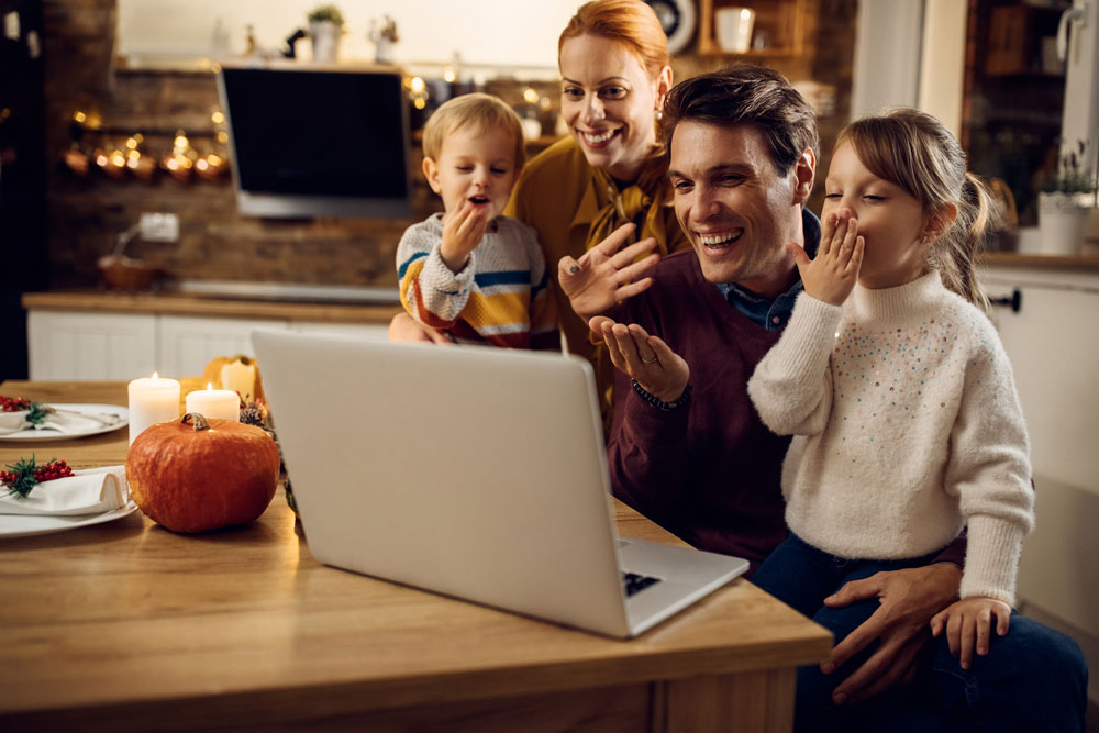 Family makes virtual call with computer during Thanksgiving