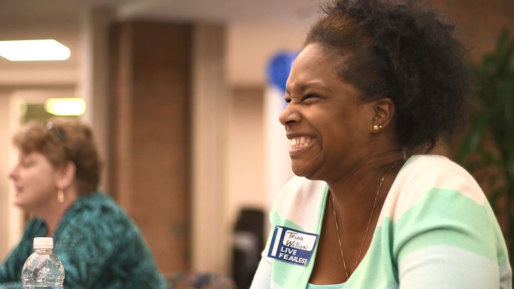 Female BlueCross employee with big smile