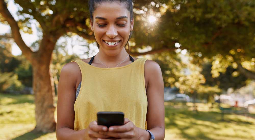 woman with phone in park