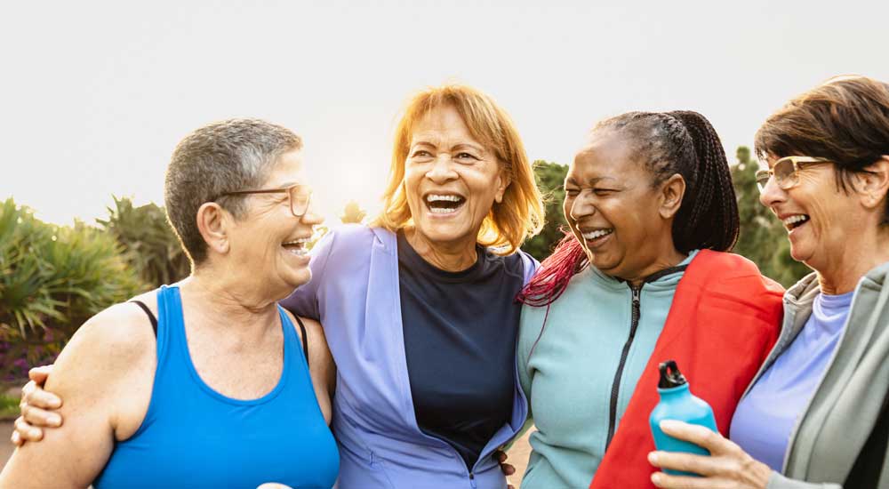 group of older women smiling outside