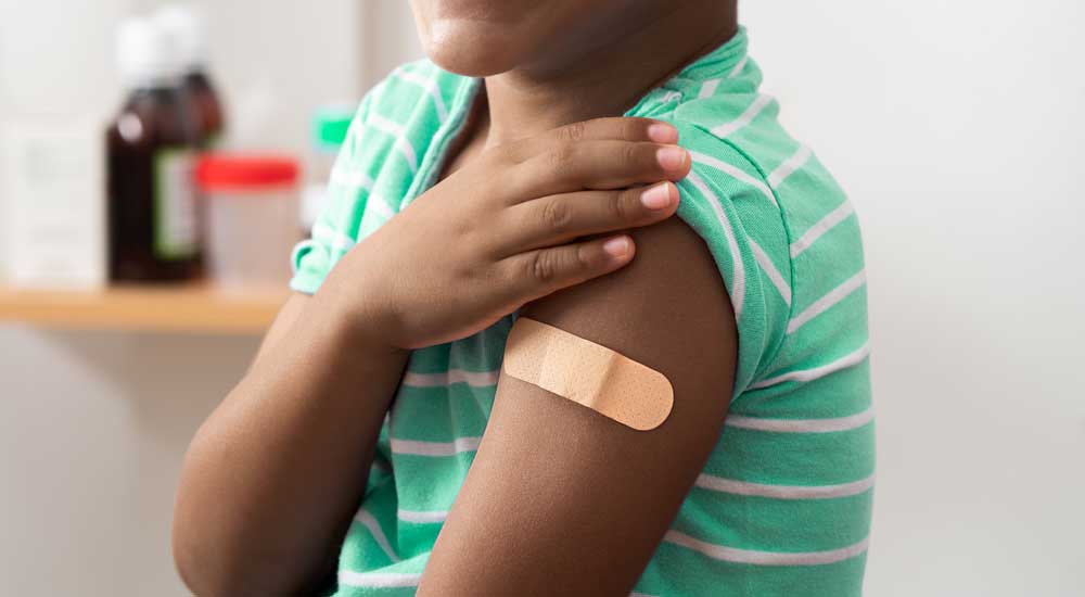 close up of boy's shoulder with bandage