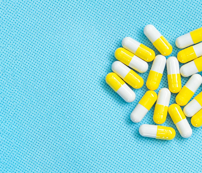 bright blue background with yellow and white pills