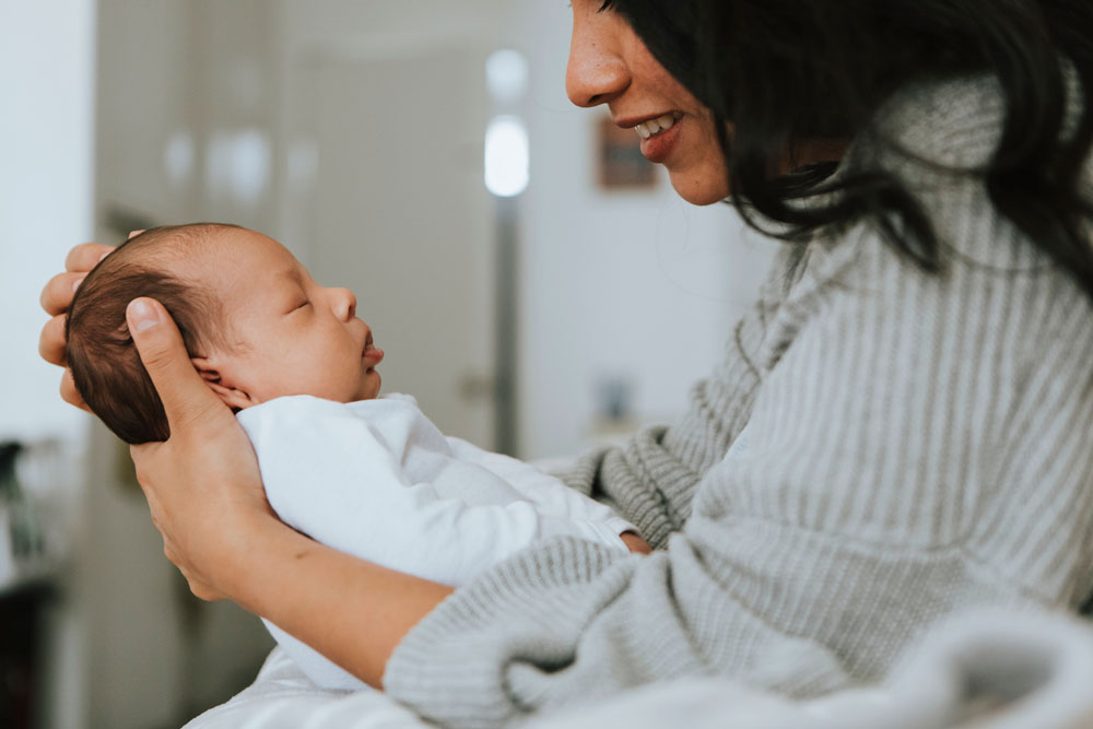 mom holds newborn baby