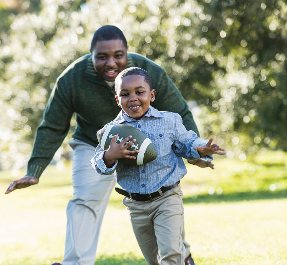 Father and son playing backyard football