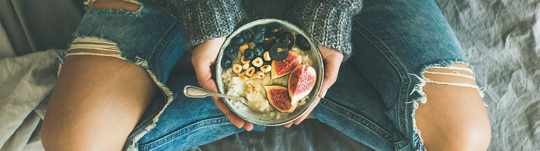 Bowl of fruit in a womans lap