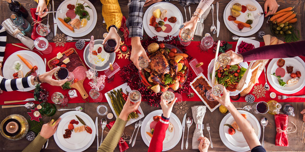 Holiday table piled with food