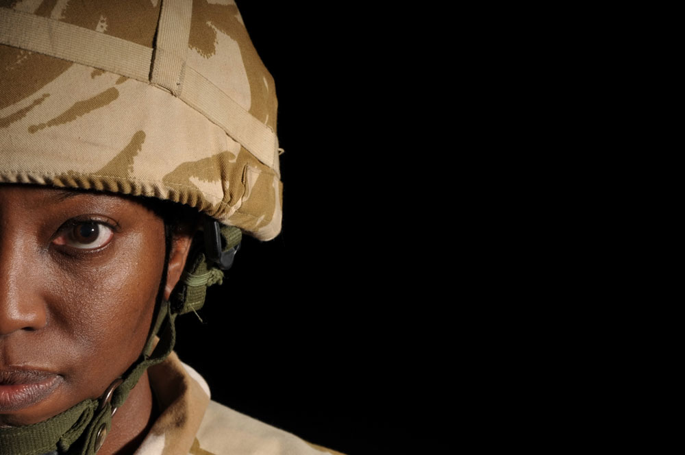 woman in military helmet looks at camera