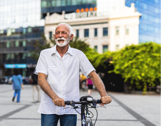 man holding a bicycle outside 