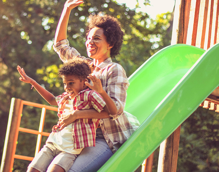 woman on slide with little boy