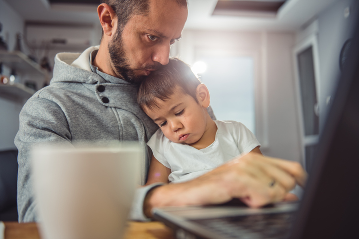 man works from home with kid