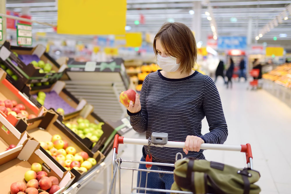 woman wears mask in grocery store