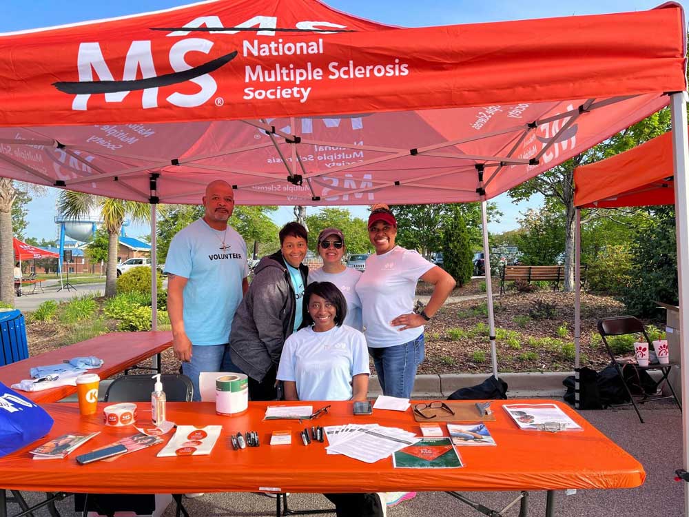 group of people standing behind table at volunteer event