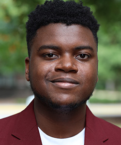 Alexander Mills, a young male student at Claflin University, smiles into the camera.